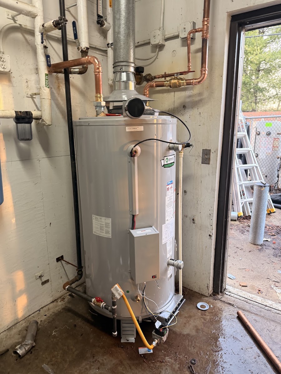 Newly installed gas water heater with copper supply lines, professionally installed